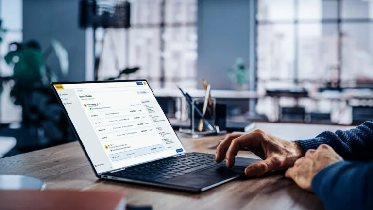 A laptop with the DACHSER platform displayed on its screen.